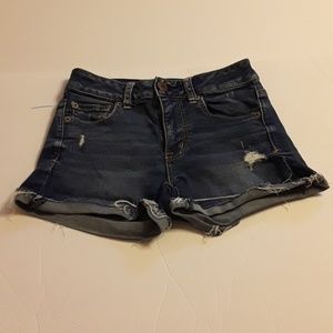 Light blue ripped American Eagle midi shorts